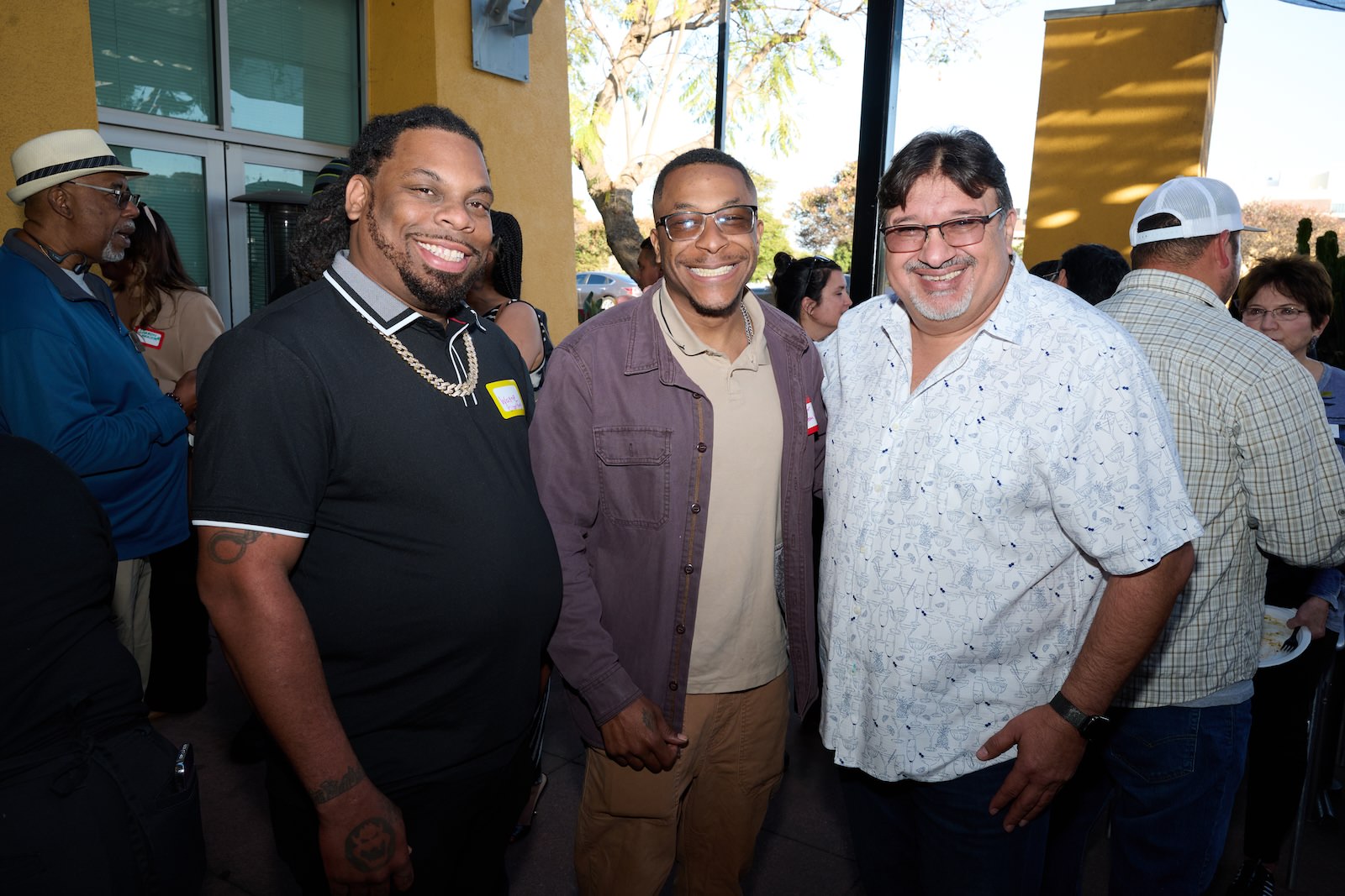 3 men posing and smiling at the May Mixer