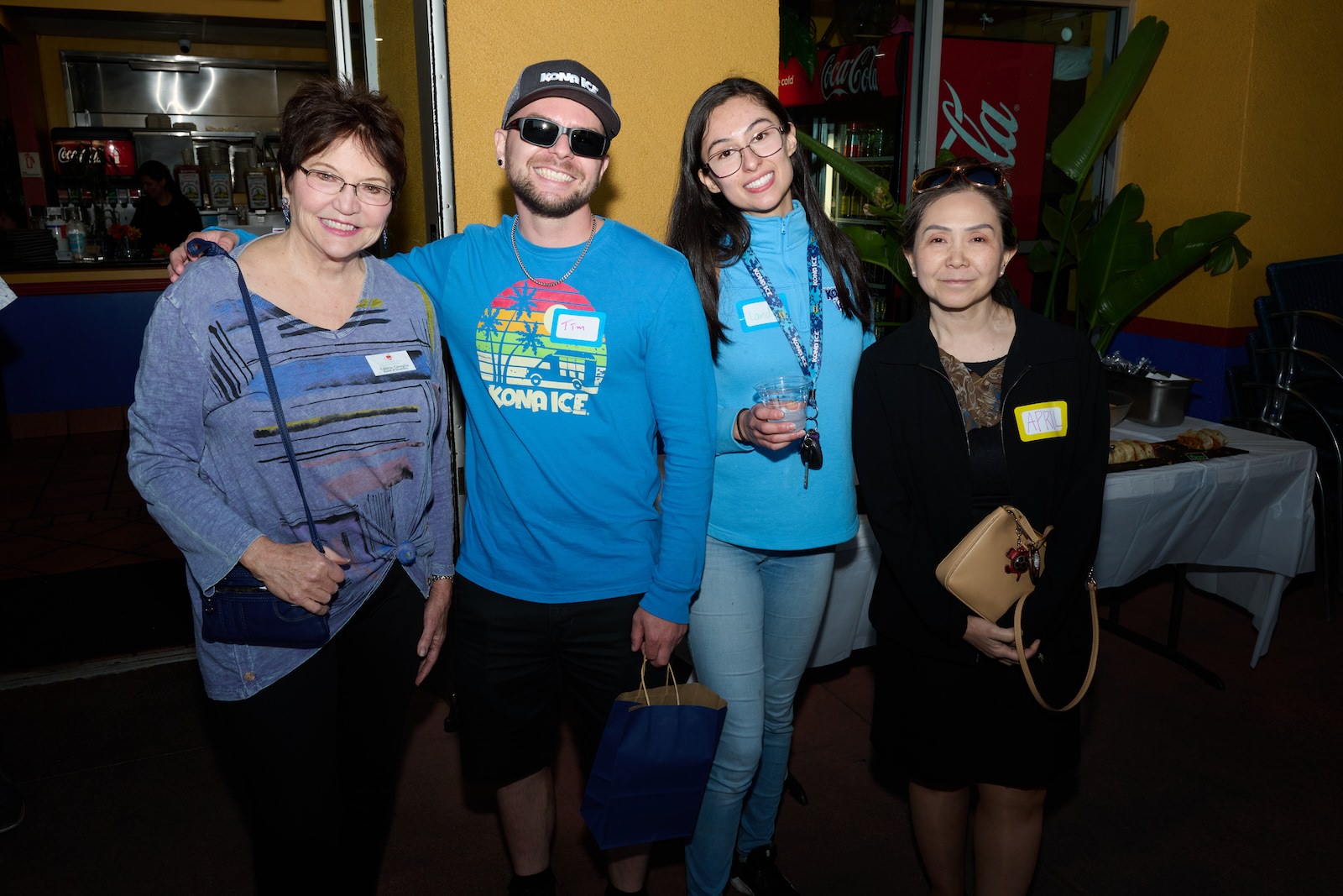 a man and 3 women posing and smiling at the May Mixer